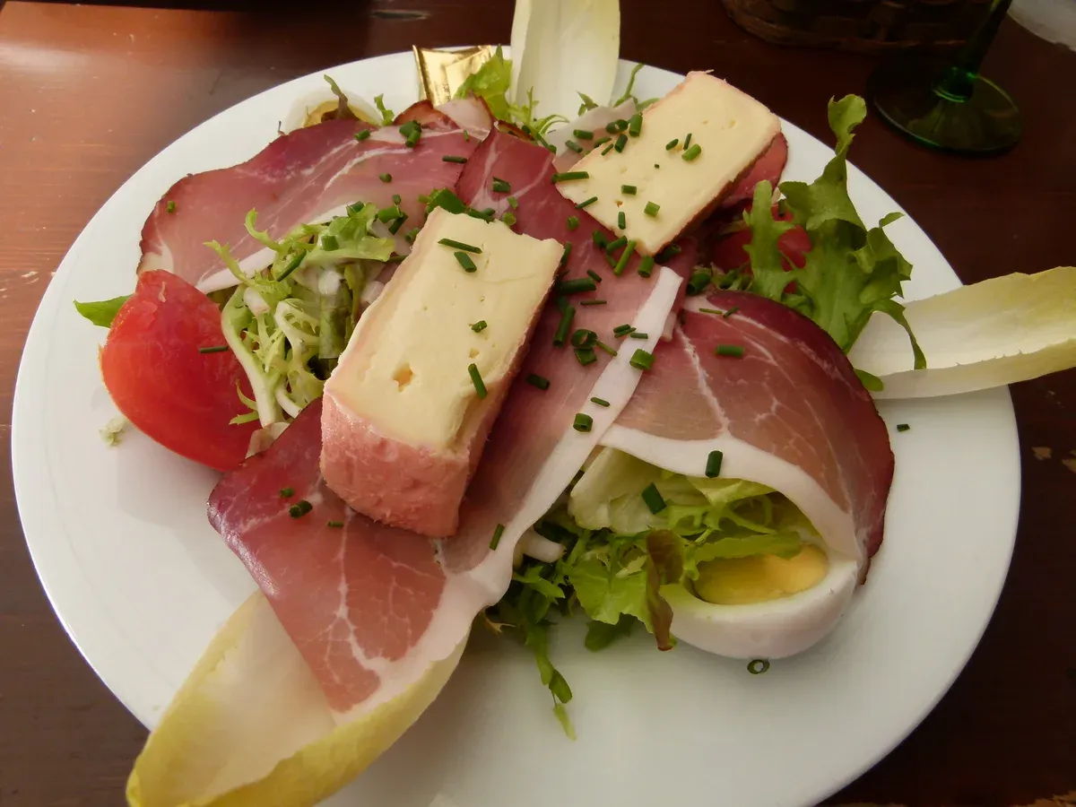 Alsatian plate of cured ham, Munster-style cheese, egg and salad