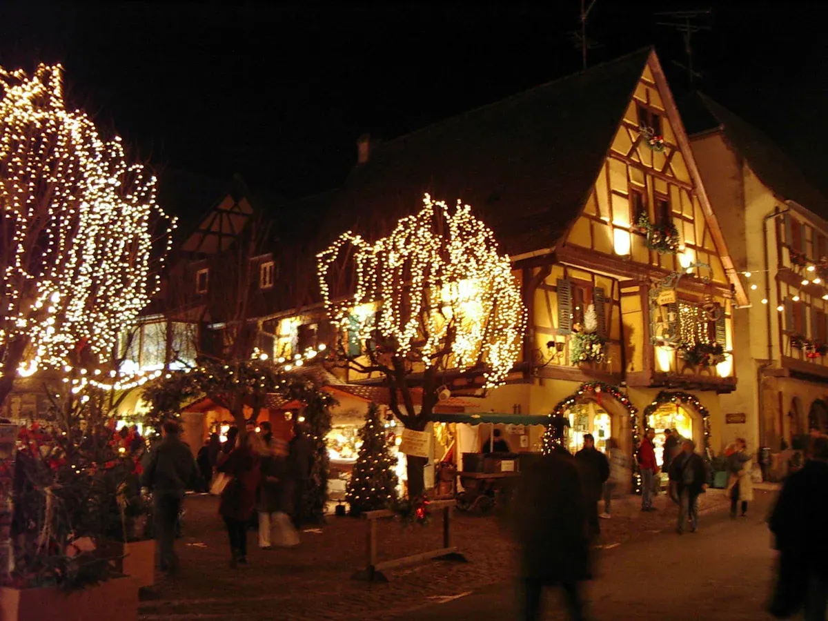 Eguisheim half-timbered square lit with Christmas lights at night
