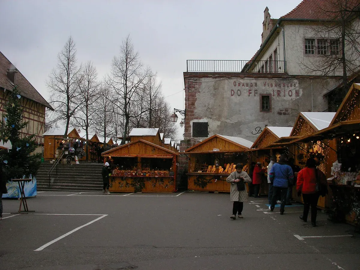 Wooden market chalets on a square in Riquewihr in winter